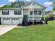 Charming home with a manicured lawn, covered porch, and a two-car garage with beautiful modern curb appeal at 319 Primrose Ln, Auburn, GA 30011