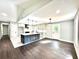 Well-lit open kitchen with light cabinets, dark island, and a view to the front door at 319 Primrose Ln, Auburn, GA 30011