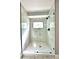 Elegant glass-enclosed shower with marble tile, black fixtures, and built-in TV at 319 Primrose Ln, Auburn, GA 30011