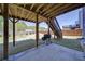 Covered patio featuring a grill with a view of the backyard and staircase to the deck at 3690 Summerpoint Xing, Cumming, GA 30028