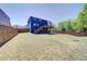 Expansive fenced backyard with a lush lawn and a two-story home featuring a wooden deck at 3690 Summerpoint Xing, Cumming, GA 30028