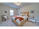 Bedroom with a wood-frame bed with decorative pillows, side tables, a chair, and framed art at 3690 Summerpoint Xing, Cumming, GA 30028