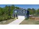 Charming two-story home with a well-manicured lawn and a paved driveway in a suburban setting at 3690 Summerpoint Xing, Cumming, GA 30028