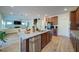 Kitchen and living space featuring an island with stainless steel dishwasher at 3690 Summerpoint Xing, Cumming, GA 30028