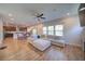 Spacious open-concept living room with hardwood floors, modern furnishings, and abundant natural light at 3690 Summerpoint Xing, Cumming, GA 30028