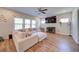 Bright and airy living room featuring a large sectional sofa, hardwood floors and a large-screen TV at 3690 Summerpoint Xing, Cumming, GA 30028