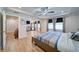 Spacious main bedroom featuring tray ceilings, a ceiling fan, and a large window for plenty of natural light at 3690 Summerpoint Xing, Cumming, GA 30028