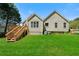 Exterior view of backyard with green grass, wooden deck with stairs, and siding at 4512 Terret Nw Trce, Acworth, GA 30101