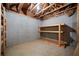 Unfinished basement featuring exposed wood beams, insulation, and shelving for storage at 4512 Terret Nw Trce, Acworth, GA 30101