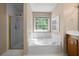Bathroom with shower, tub, and large garden window at 4512 Terret Nw Trce, Acworth, GA 30101