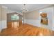 Dining room shows chandelier, wainscoting and hardwood floors in an open concept design at 4512 Terret Nw Trce, Acworth, GA 30101