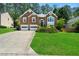Charming brick two-story home with a two-car garage and lush green lawn at 4512 Terret Nw Trce, Acworth, GA 30101
