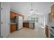 Open kitchen featuring oak cabinets, white appliances, and tiled flooring at 4512 Terret Nw Trce, Acworth, GA 30101