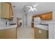 Kitchen featuring oak cabinets, tiled flooring and modern white appliances at 4512 Terret Nw Trce, Acworth, GA 30101