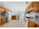 Charming kitchen with oak cabinets, white appliances, and tiled flooring at 4512 Terret Nw Trce, Acworth, GA 30101