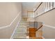 Well-lit staircase with carpeted steps and wooden railing, leading to the second floor at 4512 Terret Nw Trce, Acworth, GA 30101