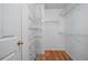 Spacious walk-in closet with white wire shelving and hardwood floors at 4512 Terret Nw Trce, Acworth, GA 30101