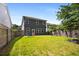 Manicured backyard featuring healthy green grass and a wooden fence along the perimeter at 458 Burgundy Se Ter, Atlanta, GA 30354