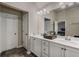 Bright bathroom featuring a double sink vanity with modern fixtures and dark tile flooring at 458 Burgundy Se Ter, Atlanta, GA 30354
