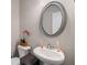 Bathroom featuring oval mirror and pedestal sink at 458 Burgundy Se Ter, Atlanta, GA 30354