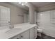 Clean bathroom with a white single sink vanity, large mirror, and bathtub with shower at 458 Burgundy Se Ter, Atlanta, GA 30354