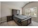 Bedroom featuring wood furnishings and a vaulted ceiling with a window at 458 Burgundy Se Ter, Atlanta, GA 30354