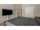 Spacious bedroom with large-screen TV and walk-in closet at 458 Burgundy Se Ter, Atlanta, GA 30354