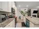 Bright kitchen with granite counters, stainless appliances, undermount sink, and white cabinets at 458 Burgundy Se Ter, Atlanta, GA 30354