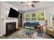 Cozy living room with a fireplace, built-in bookshelves, and large windows at 458 Burgundy Se Ter, Atlanta, GA 30354