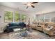 Open living space featuring a ceiling fan and large windows at 458 Burgundy Se Ter, Atlanta, GA 30354