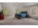 Spacious main bedroom featuring neutral colors, carpet, ceiling fan and several windows for natural light at 458 Burgundy Se Ter, Atlanta, GA 30354
