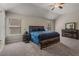 Spacious main bedroom featuring neutral colors, carpet, ceiling fan and several windows for natural light at 458 Burgundy Se Ter, Atlanta, GA 30354