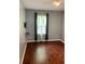 This bedroom features hardwood floors, modern gray paint, and a window providing natural light at 5897 Strathmoor Manor Cir, Lithonia, GA 30058