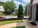 Cozy red brick home with an open front door, wrought iron fence, and landscaped yard at 5897 Strathmoor Manor Cir, Lithonia, GA 30058
