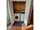 Convenient laundry area hidden behind louvered doors, with appliances and storage at 5897 Strathmoor Manor Cir, Lithonia, GA 30058