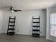 Bright living room featuring a ceiling fan, modern shelving, and large windows providing natural light at 5897 Strathmoor Manor Cir, Lithonia, GA 30058