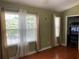 Inviting living room with gleaming hardwood floors and sun-filled windows, creating a warm and welcoming space at 5897 Strathmoor Manor Cir, Lithonia, GA 30058
