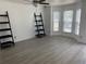 Neutral living space with hardwood flooring, fan, and a bay window offering an abundance of natural light at 5897 Strathmoor Manor Cir, Lithonia, GA 30058