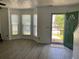 Open-concept living room with ample natural light from the bay windows and stylish front door entrance at 5897 Strathmoor Manor Cir, Lithonia, GA 30058