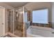 Bathroom features a large walk-in shower with grey tiling and a soaking tub at 3419 Mulberry Cove Way, Auburn, GA 30011