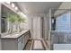 Bathroom features double sinks, granite countertops, tile floors, and tiled shower with glass door at 3419 Mulberry Cove Way, Auburn, GA 30011