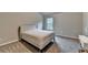 Bright bedroom featuring a bed, carpet flooring, a window, and a vanity table at 3419 Mulberry Cove Way, Auburn, GA 30011