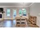 Dining area featuring a wooden table, natural light, and access to the outdoor patio at 3419 Mulberry Cove Way, Auburn, GA 30011