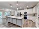 Modern kitchen with a large center island, stainless steel appliances, and white cabinetry at 3419 Mulberry Cove Way, Auburn, GA 30011