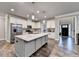 Spacious kitchen featuring a large island, stainless steel appliances, and hardwood floors at 3419 Mulberry Cove Way, Auburn, GA 30011