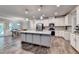Open-concept kitchen featuring a spacious island, stainless steel appliances, and hardwood flooring at 3419 Mulberry Cove Way, Auburn, GA 30011