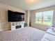 Bright living room with a large window, display shelves, and comfortable seating arrangement at 3419 Mulberry Cove Way, Auburn, GA 30011