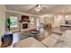 Open-concept living room with fireplace, hardwood floors, and access to dining and kitchen areas at 3419 Mulberry Cove Way, Auburn, GA 30011