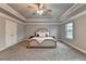 Bright main bedroom features decorative ceiling, plush carpet and abundant natural light, and plenty of closet space at 3419 Mulberry Cove Way, Auburn, GA 30011