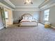 Spacious main bedroom featuring a trey ceiling, plush carpet, a king bed and ensuite access at 3419 Mulberry Cove Way, Auburn, GA 30011